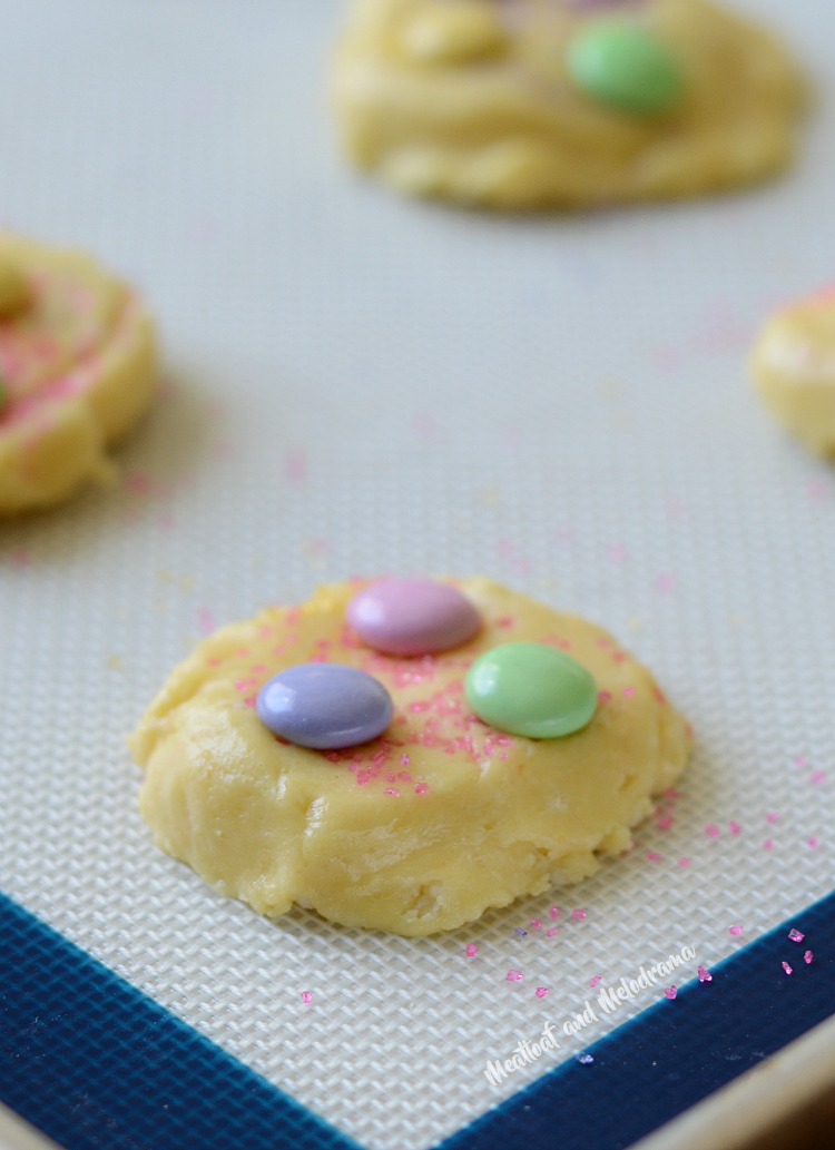 spring cake mix cookies with pastel candies and colored sugar on baking sheet