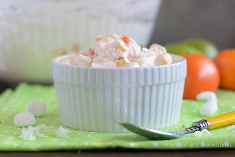 easy ambrosia fruit salad with oranges, pineapple, coconut and sour cream in white bowl