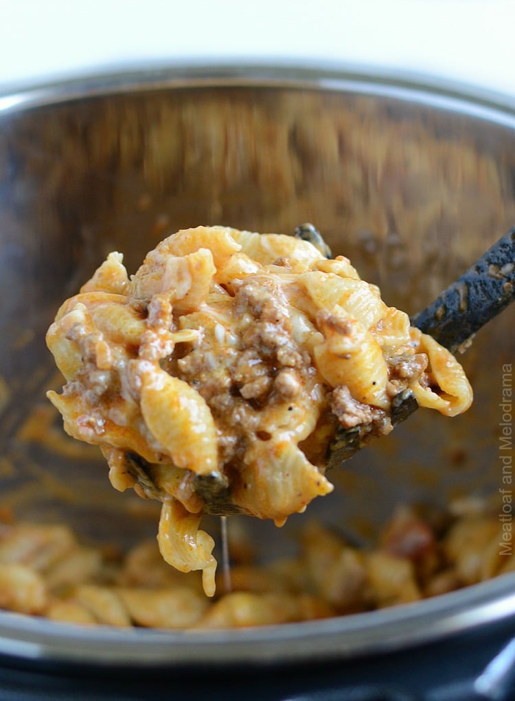 instant pot creamy taco pasta on serving spoon