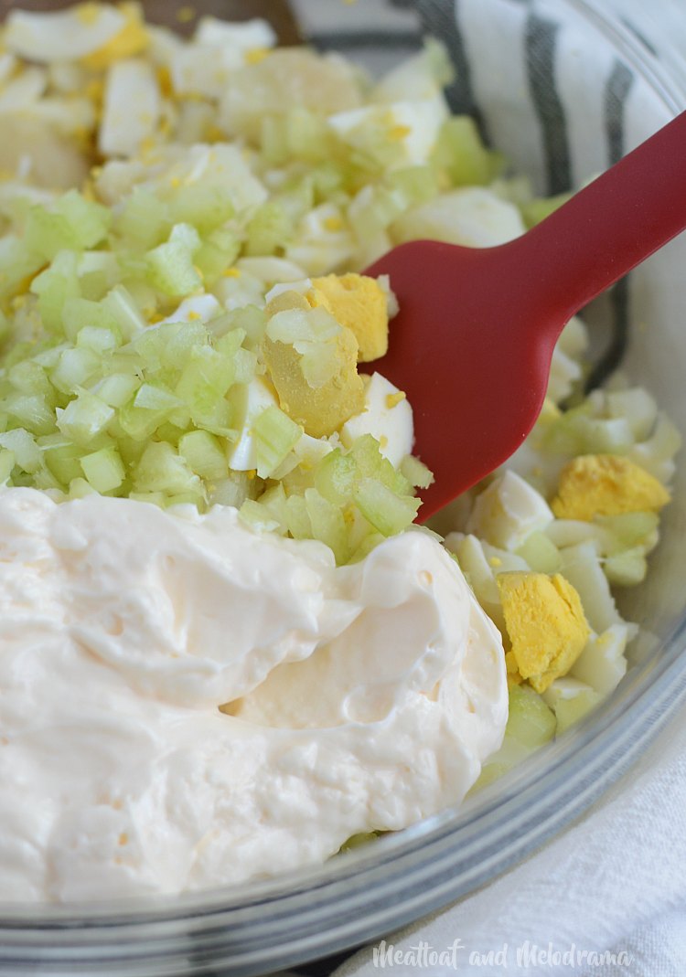 mix potato salad ingredients in bowl