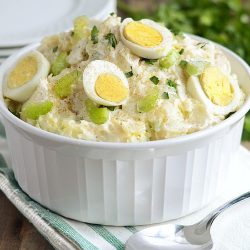 instant pot potato salad with red potatoes in a bowl with hard cooked eggs and celery
