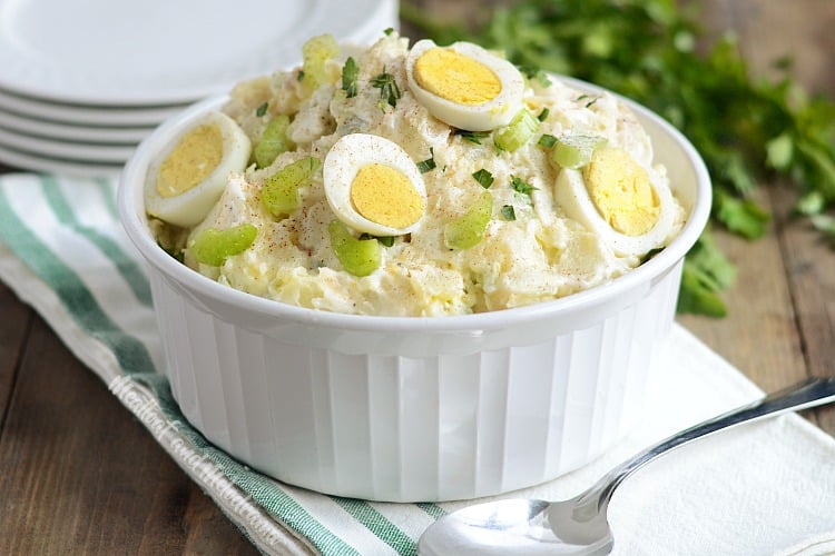 instant pot potato salad with red potatoes in a bowl with hard cooked eggs and celery