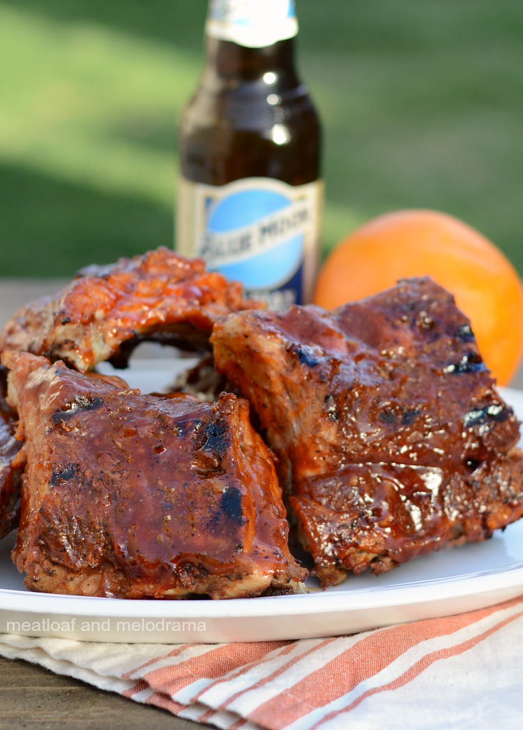 instant pot beer ribs with orange bbq sauce on platter