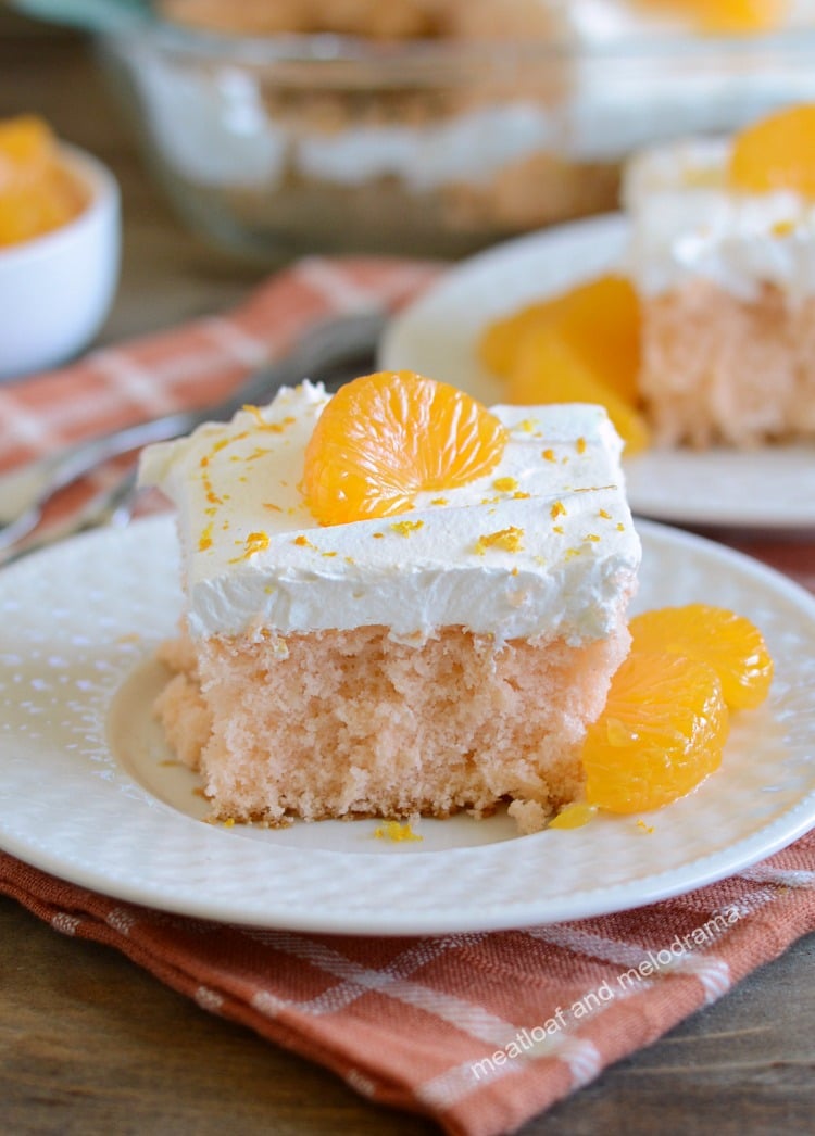 orange crush soda pop cake with whipped topping and orange slices