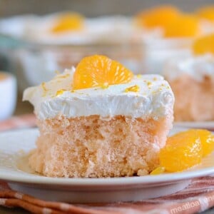 orange crush soda pop cake with cool whip frosting and mandarin orange slices