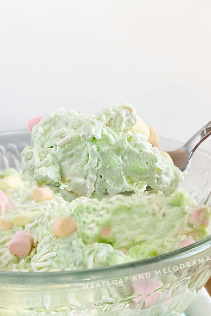 watergate salad with fruit colored marshmallows on serving spoon
