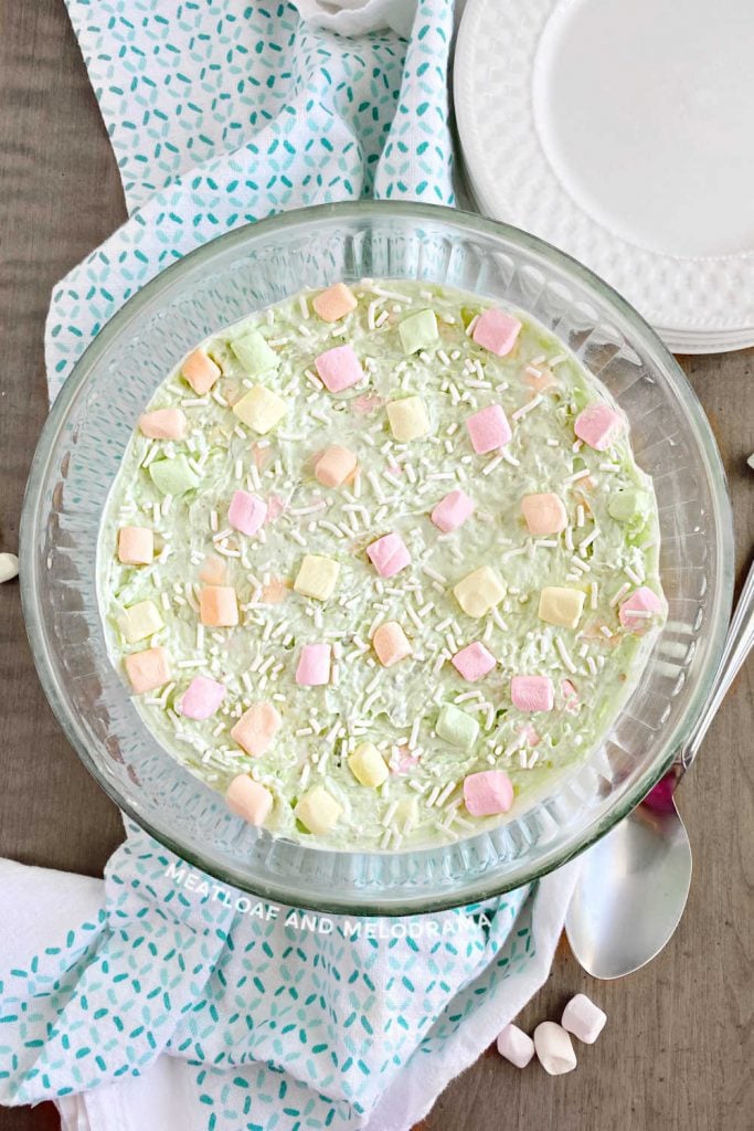pistachio salad with fruit colored marshmallows in glass bowl