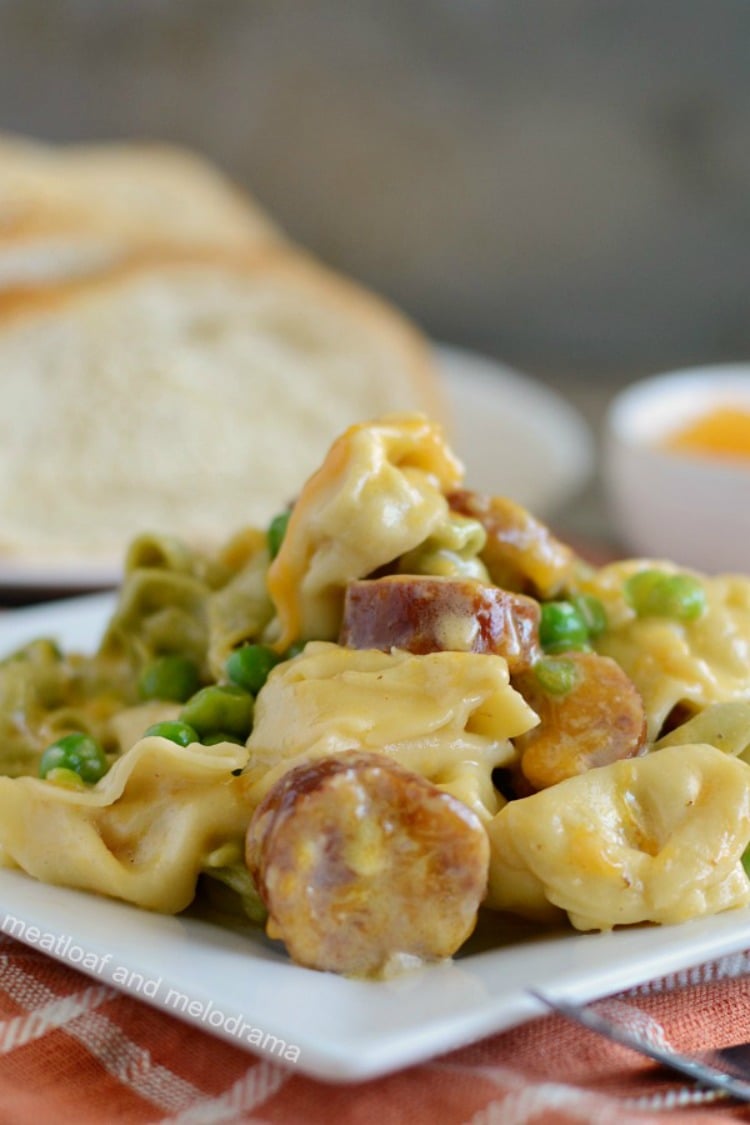 instant pot creamy kielbasa tortellini with peas and cheese on plate