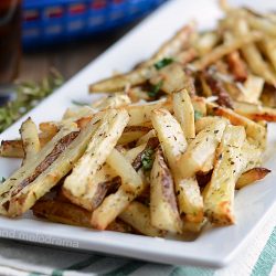 homemade baked french fries with rosemary on white platter