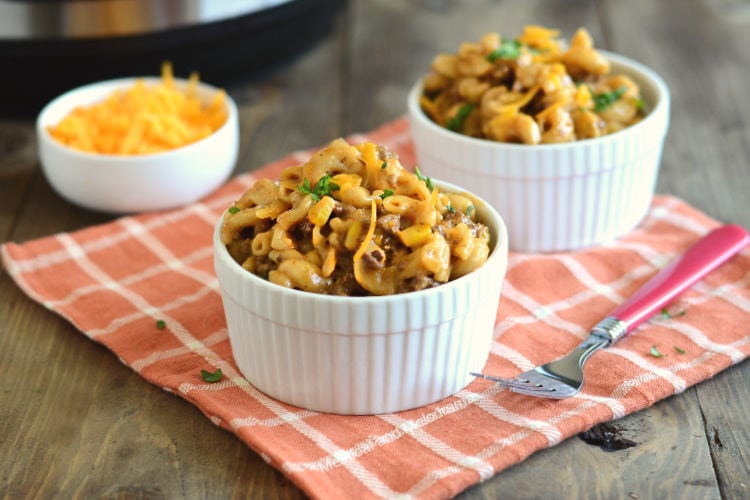 instant pot bbq macaroni and beef with cheddar cheese in white bowls