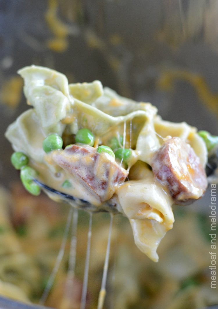 instant pot creamy kielbasa tortellini with peas on spoon 