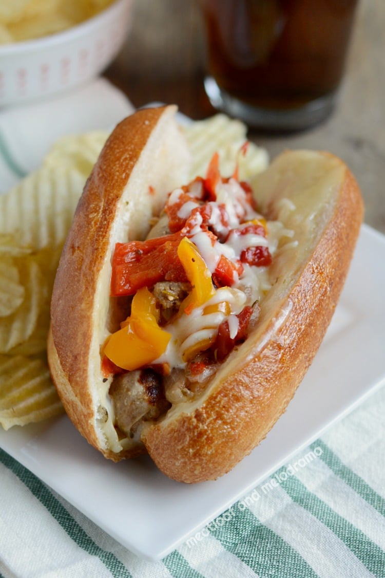 instant pot sausage and peppers with onions on sandwich roll on plate