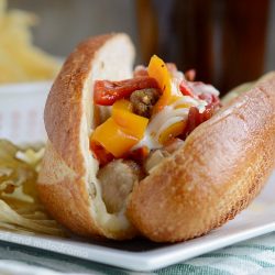 instant pot sausage and peppers with cheese on sandwich buns on plate
