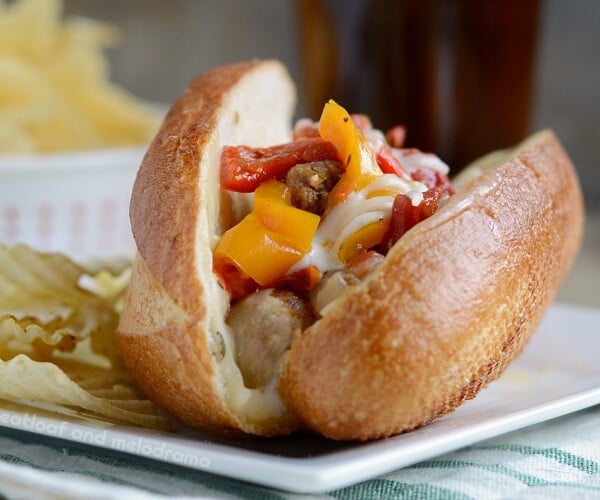 instant pot sausage and peppers with cheese on sandwich buns on plate