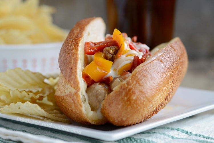 instant pot sausage and peppers with cheese on sandwich buns on plate