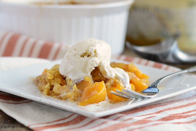 instant pot peach dump cake with vanilla ice cream on plate