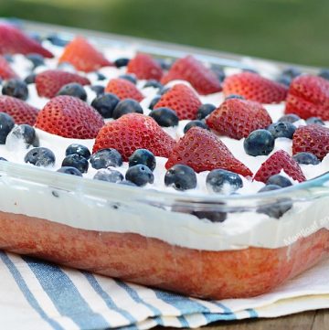 red white and blue poke cake on picnic table