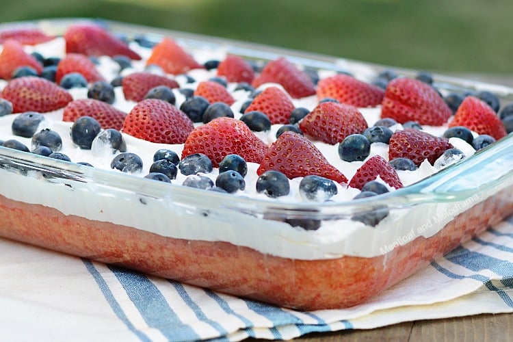 red white and blue poke cake on picnic table