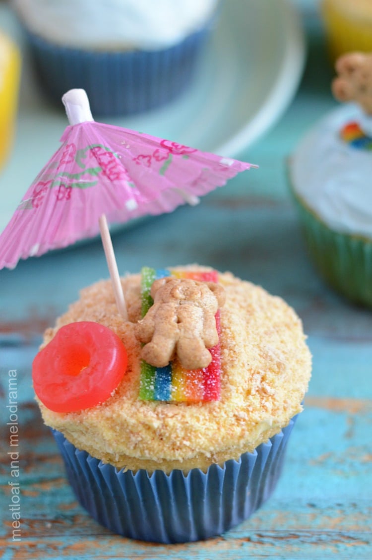 summer beach party cupcakes with teddy bear on candy blanket and umbrella