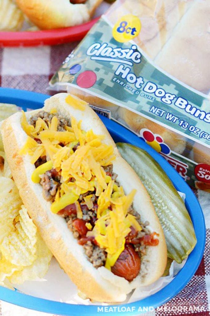 overhead view of hot dog in bun topped with cheese and beef