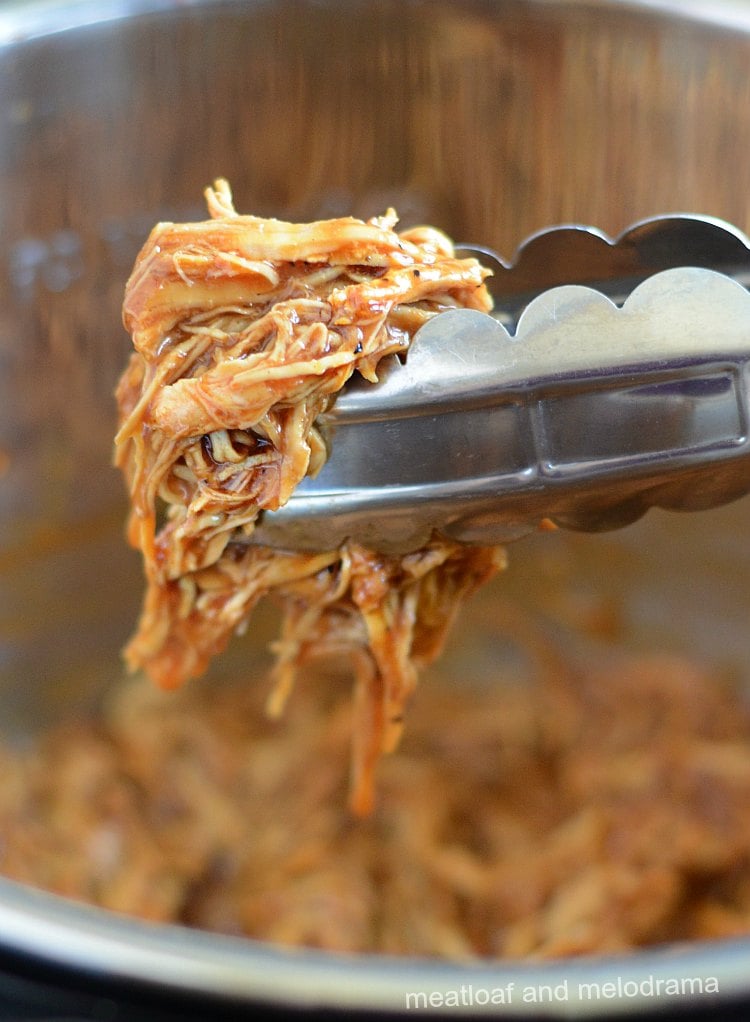 instant pot bbq pulled chicken in tongs