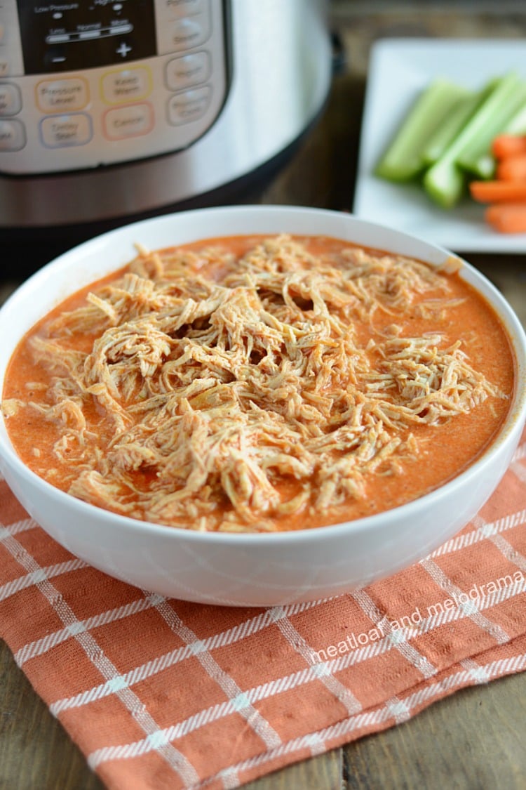instant pot buffalo chicken recipe in white bowl with carrots and celery