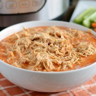 instant pot buffalo chicken recipe shredded in white bowl