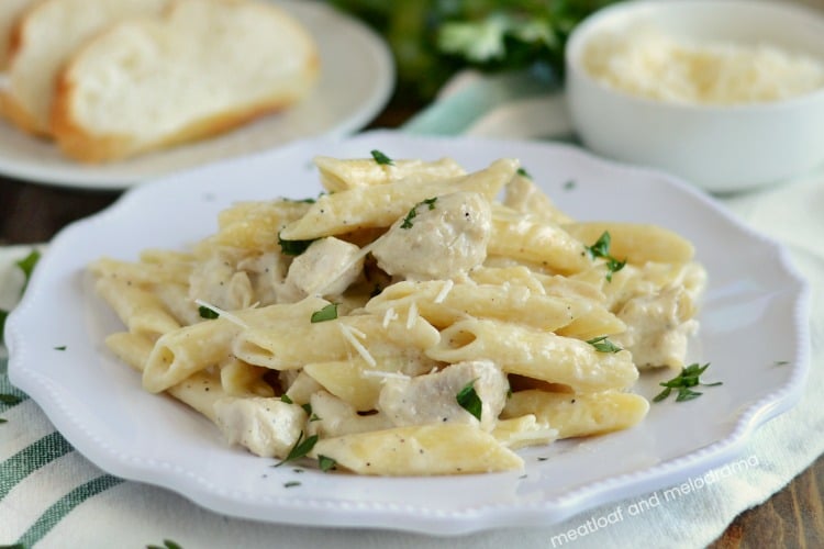 instant pot chicken alfredo penne pasta on white plate with parsley