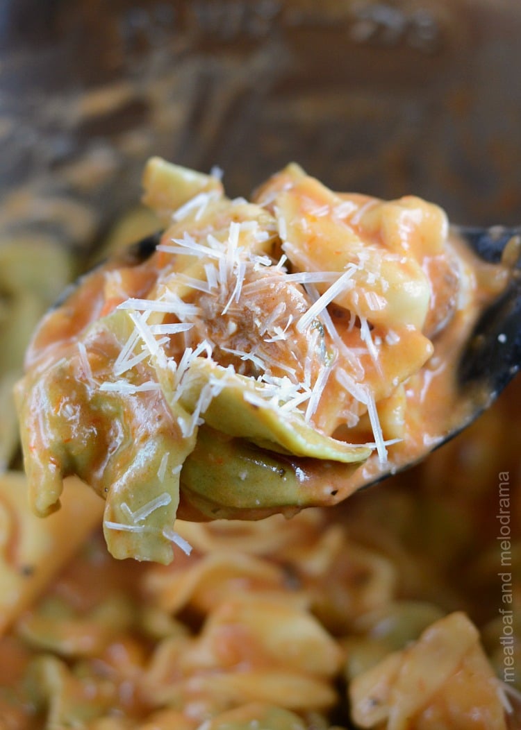 instant pot creamy sausage tortellini on spoon