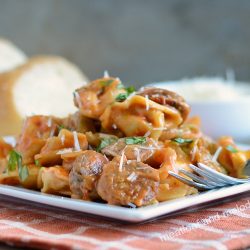 instant pot creamy sausage tortellini with basil on plate