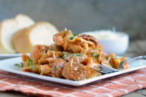 instant pot creamy sausage tortellini with basil on plate