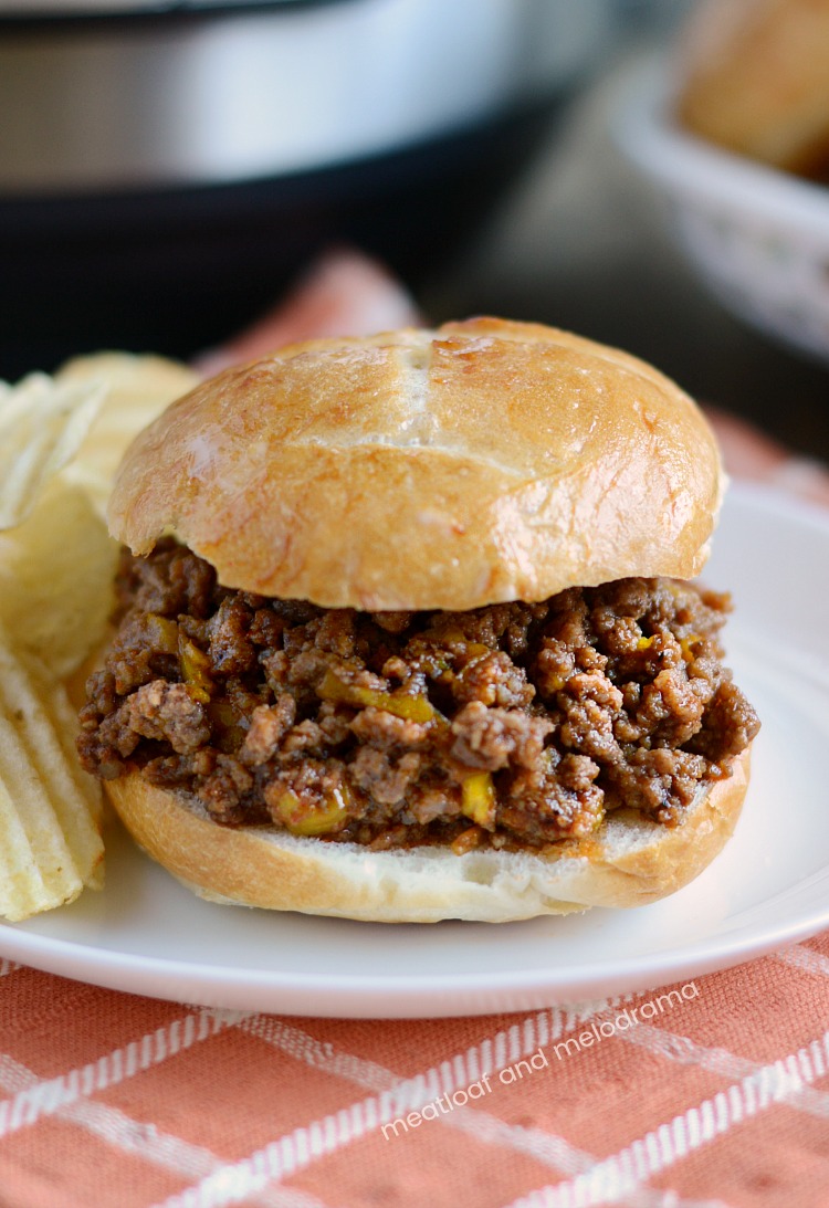 instant pot sloppy joes on a bun on white plate with chips