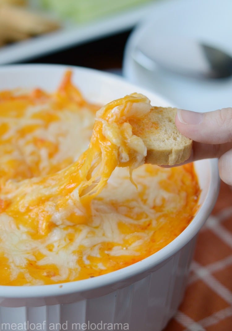 instant pot buffalo chicken dip with melted cheese on bread rounds