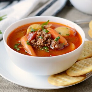 instant pot hamburger soup in white bowl with crackers