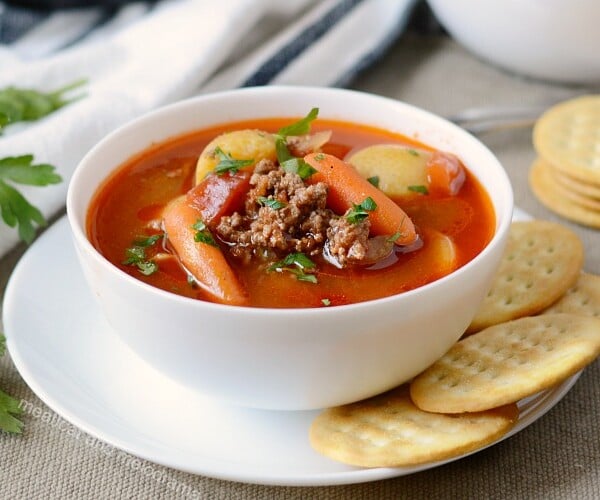 instant pot hamburger soup in white bowl with crackers