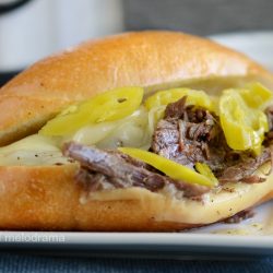 instant pot italian beef sandwiches on roll with provolone cheese and pepperoncini