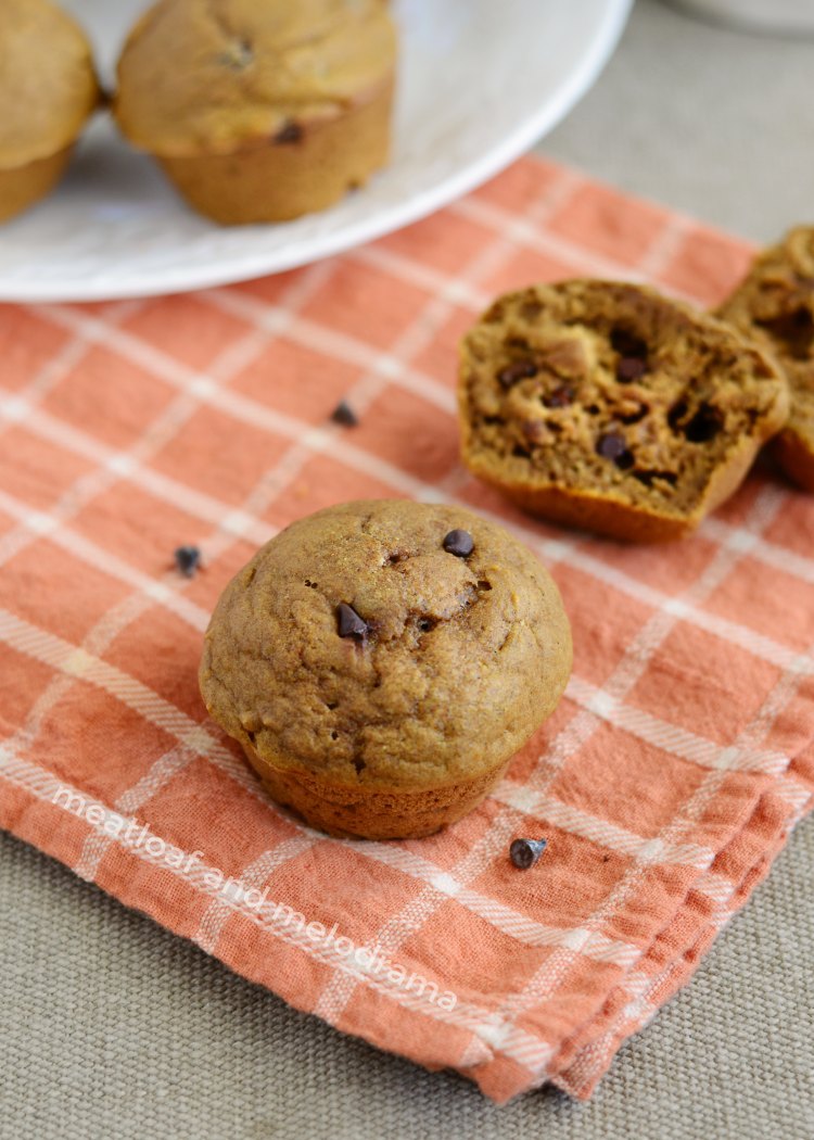 easy one bowl pumpkin spice muffins with chocolate chips on orange towel