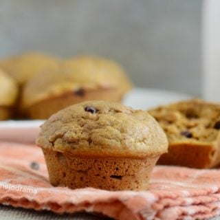 easy one bowl pumpkin spice muffin with chocolate chips on napkin