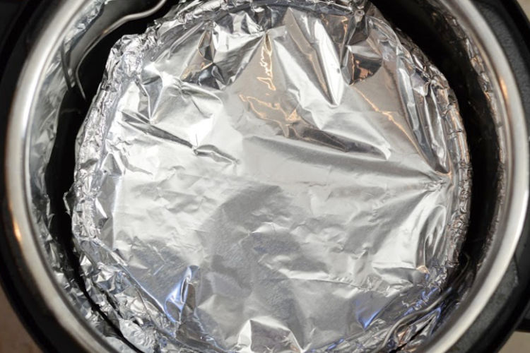 instant pot corn casserole topped with foil in pressure cooker
