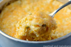 instant pot corn casserole with cheese on a spoon