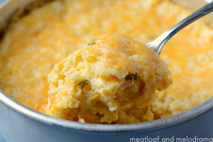 instant pot corn casserole with cheese on a spoon