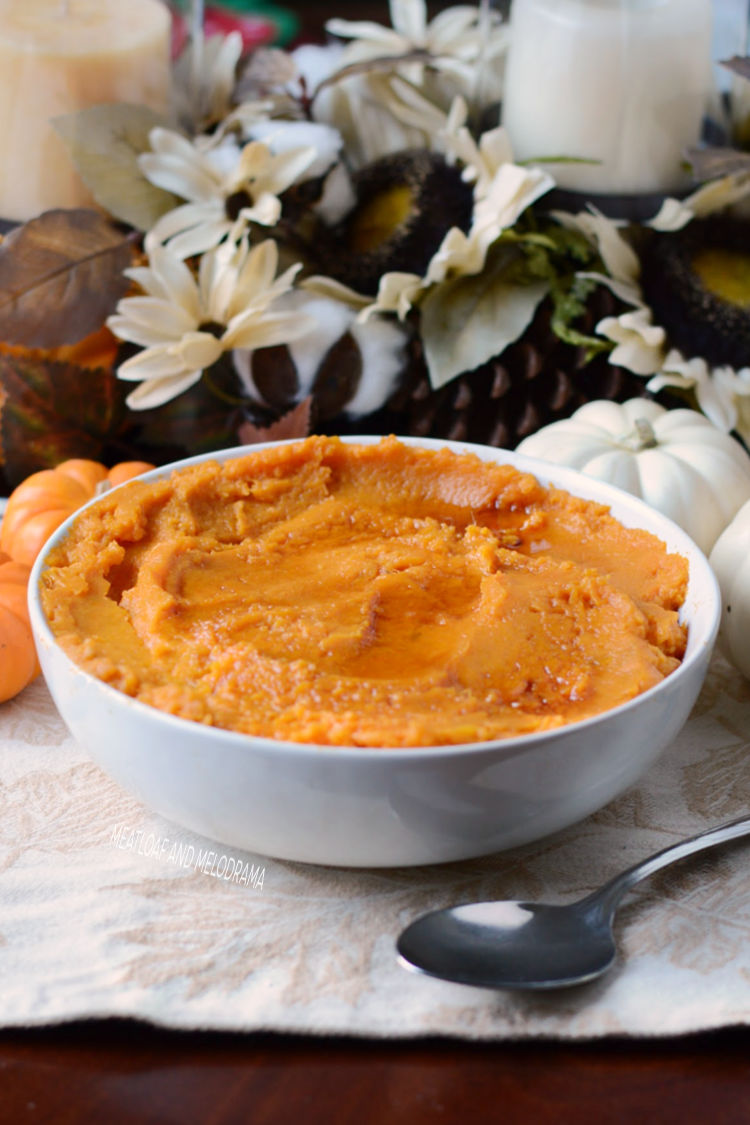 instant pot mashed sweet potatoes topped with maple syrup in white serving bowl