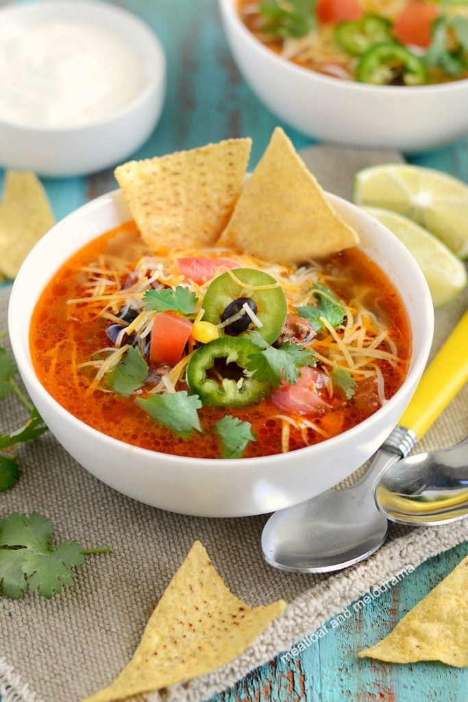 instant pot taco soup with tortilla chips, cheese, jalapeno peppers on top