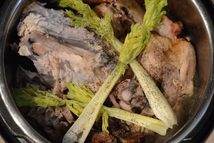 turkey carcass and water and celery in Instant Pot