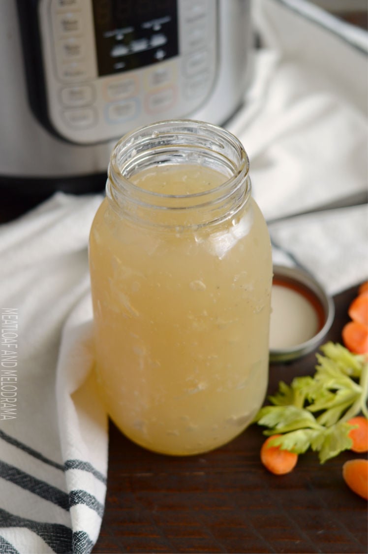 homemade instant pot turkey stock in a mason jar with celery and carrots