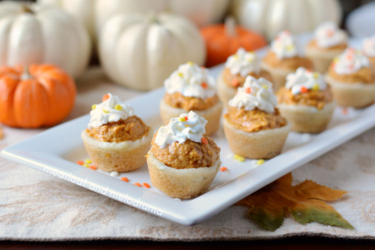 pumpkin cheesecake cookie cups with whipped cream on a serving tray for Thanksgiving