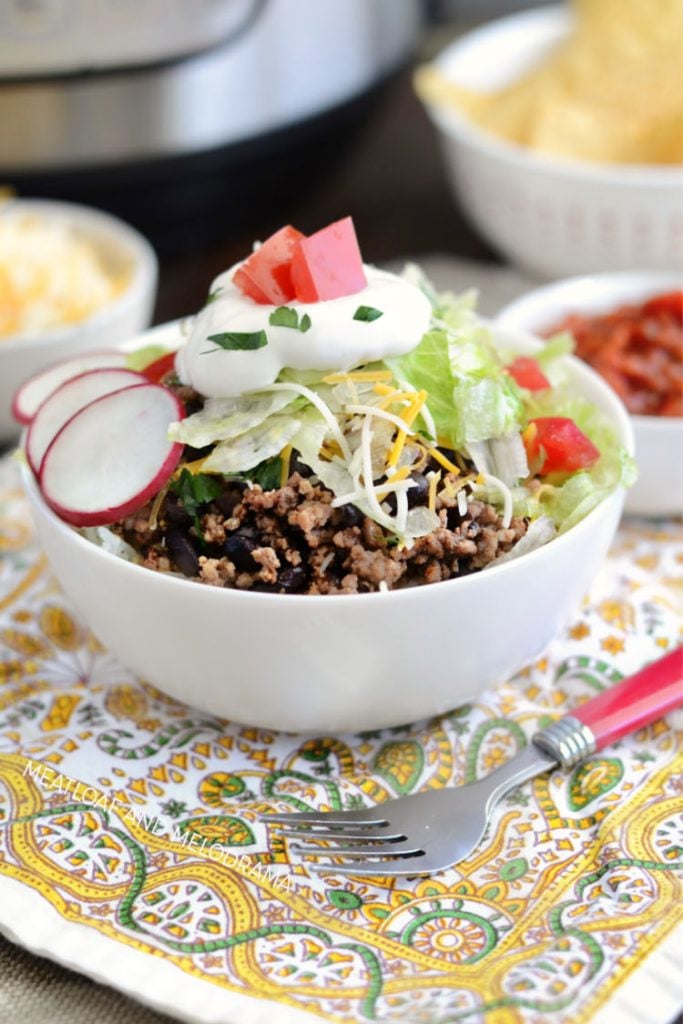 instant pot beef taco meat with black beans and rice in taco bowl