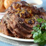 instant pot ham with cranberry orange glaze on a white platter