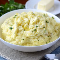 instant pot mashed potatoes with butter in a white bowl