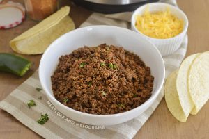 instant pot ground bee taco meat in a white bowl with cilantro